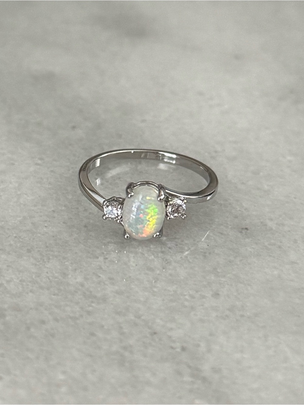 Silver Oval Opal Crystal Twist Ring 

Brand New 

Stainless Steel

Size 7